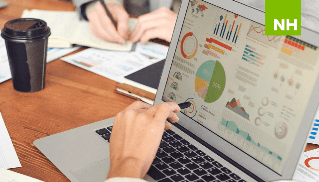 Laptop with workflow charts and stats on screen